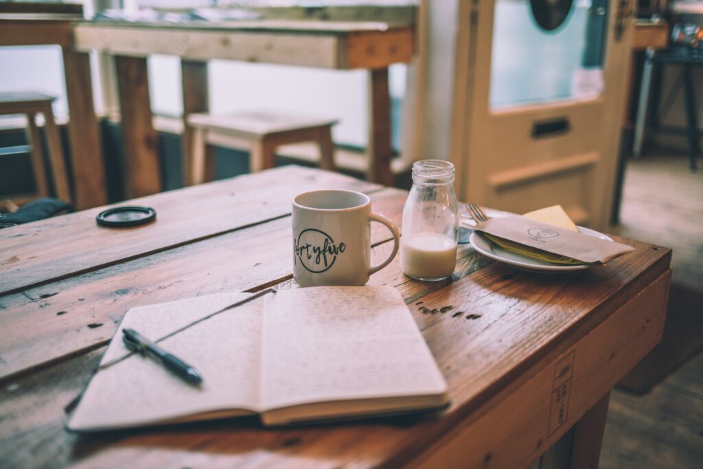 Table in bar with notebook and cup on it