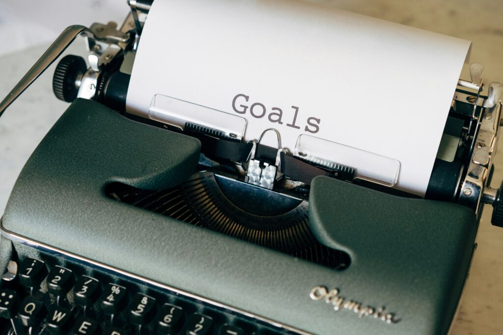 Typewriter with piece of paper in it with the word "Goals"